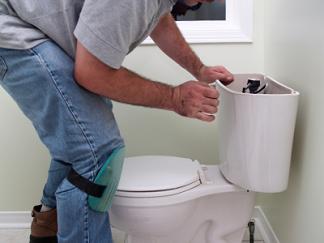 Redwood City plumbing contractor surveys a toilet