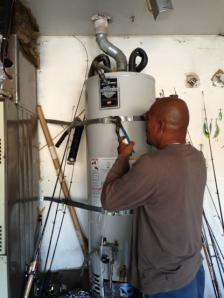 Stanley Ita secures a 40 gallon Bradford White water heater in a garage in Menlo Park